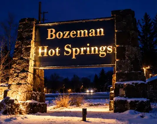 The Bozeman Hot Springs sign on a snowy winter night